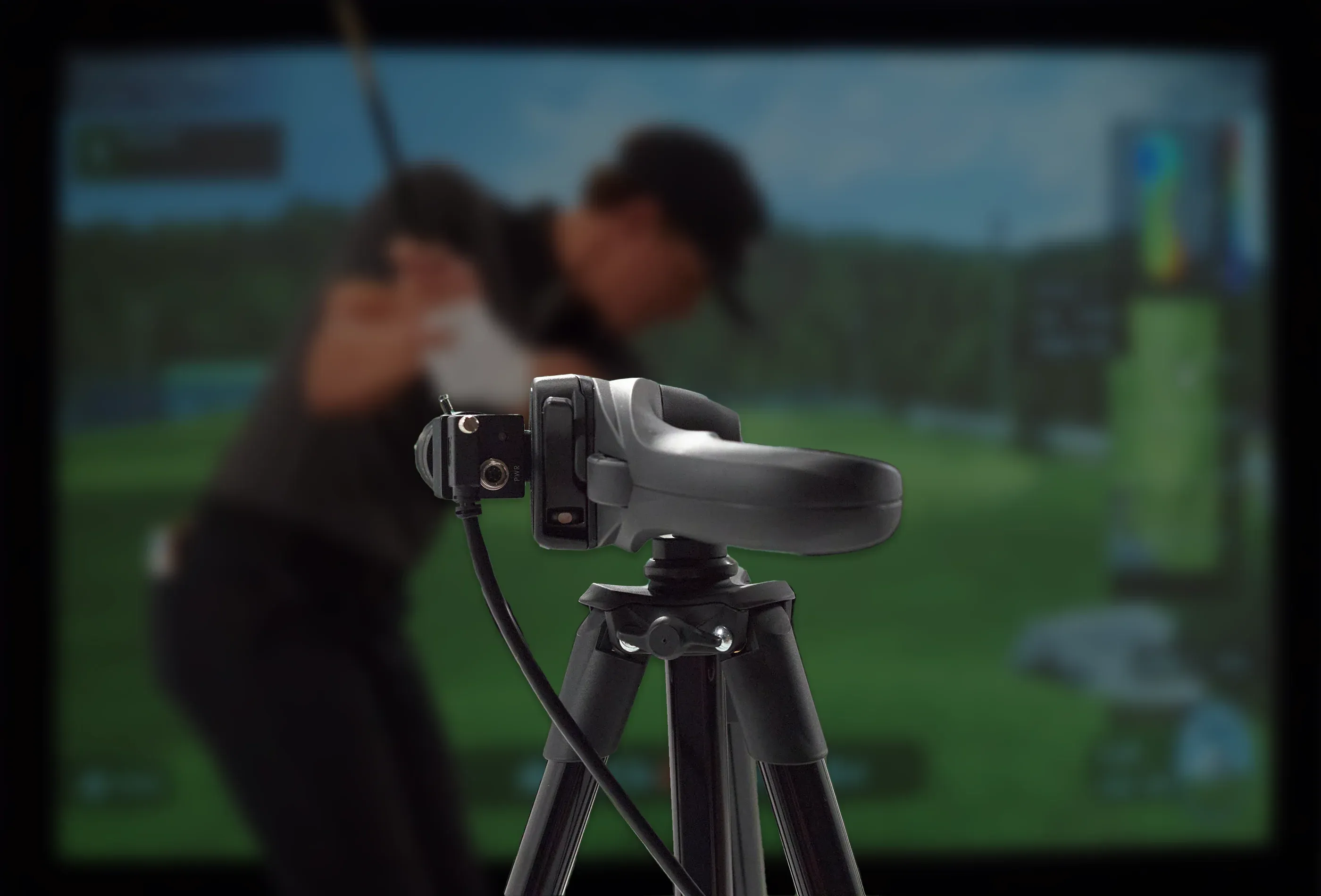 High-speed Swing Optix cameras capturing a golfer’s swing in an indoor simulator bay